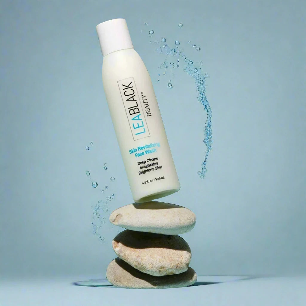 A bottle of Lea Black Beauty® Skin Revitalizing Daily Face Wash on a stack of three stones